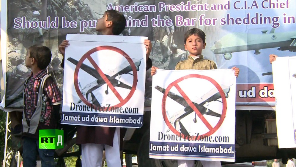 Three young boys holding anti-drone posters during a demontration against the United States' use of drones in Pakistan. Taken while shooting RTD documentary on the impact of drones, Game of Drones.
