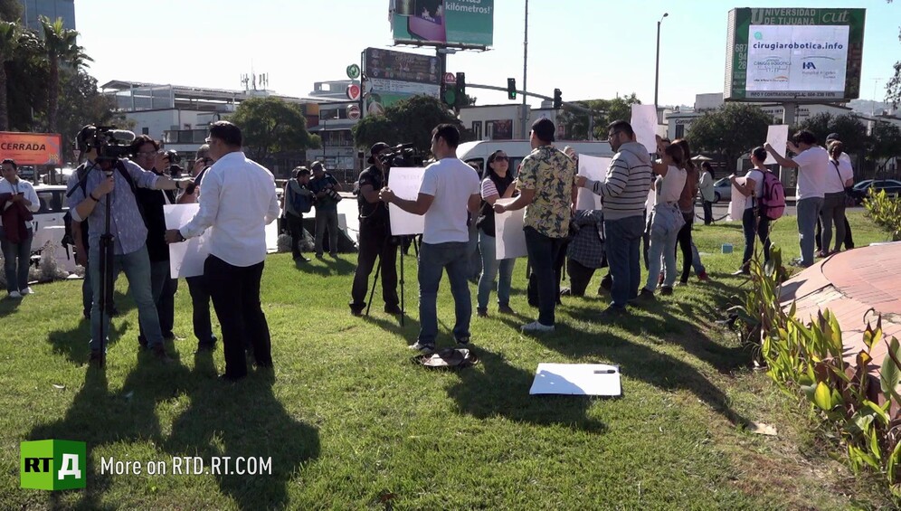 Protesters supporting the migrant caravan being filmed by journalists in Tijuana, Mexico. till taken from RTD documentary